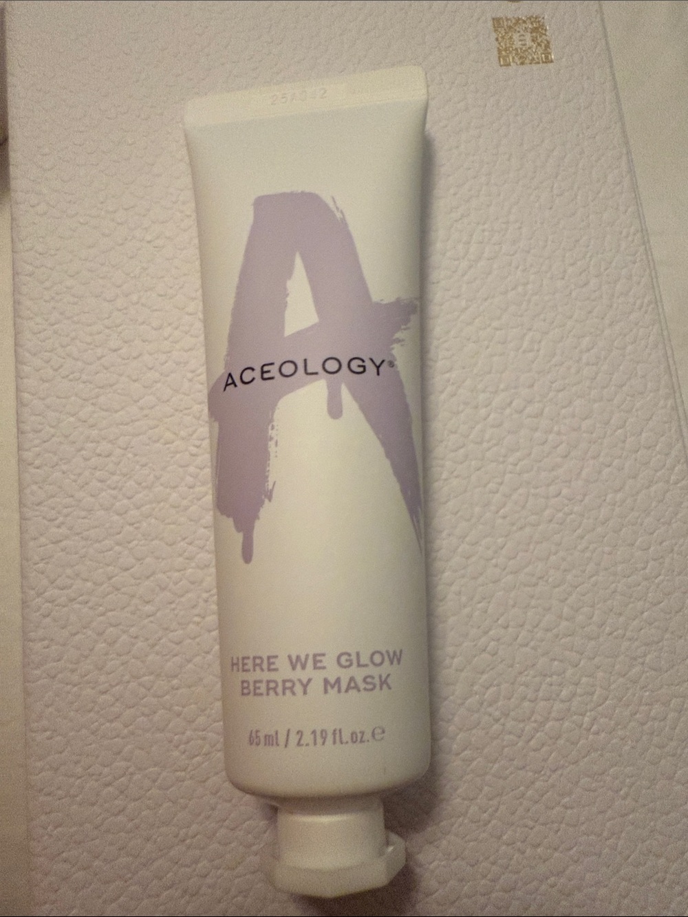 Here We Glow Berry Mask Tube - White with Lavender Text